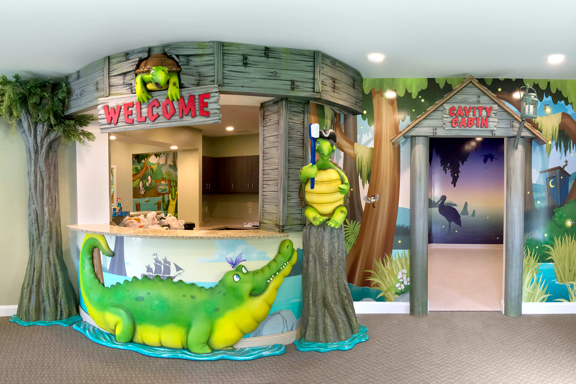 Bayou themed reception desk with sculpted cabin wood, alligator, trees and pirate turtle