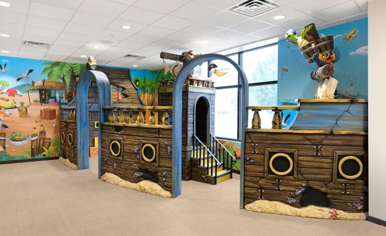 Kids shipwreck themed play area partitioned with sculpted ship walls