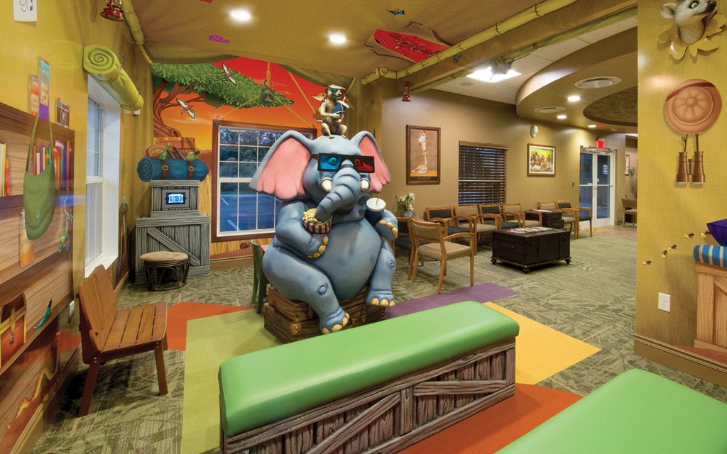 Safari tent themed theater with bench seating.