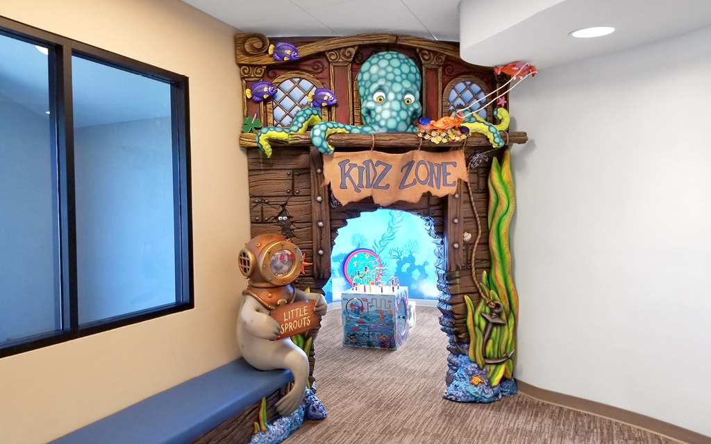 Game room entrance with pirate ship theming an seal photo op character.