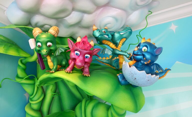 Cute, sculpted baby dragons on a magical beanstalk reaching through the clouds.