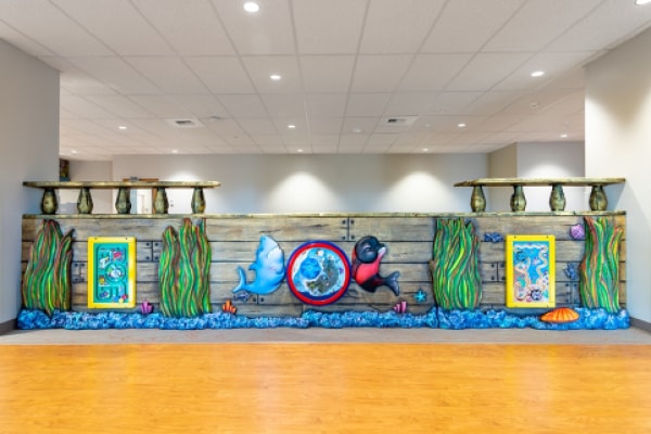 Wall of a pirate ship sectioning off a kids play area