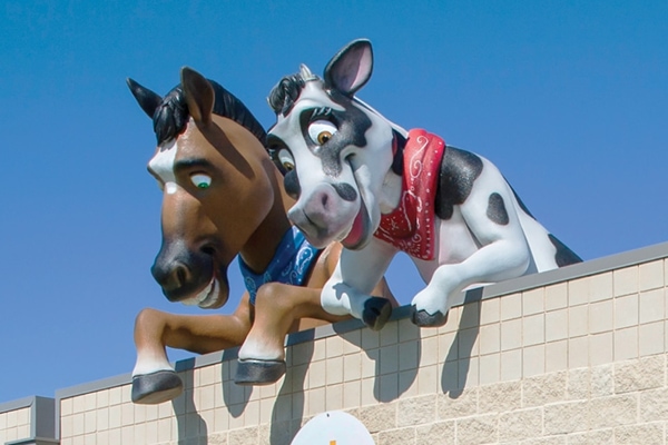 Shot of giant horse and cow rooftop landmark characters.