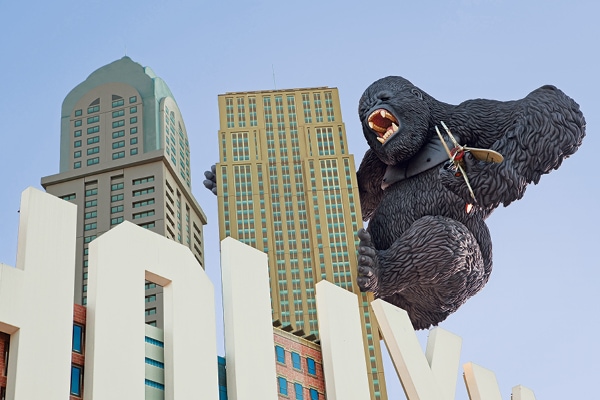Close-up exterior shot of Godzilla hanging off the outside of the Hollywood Wax Museum.