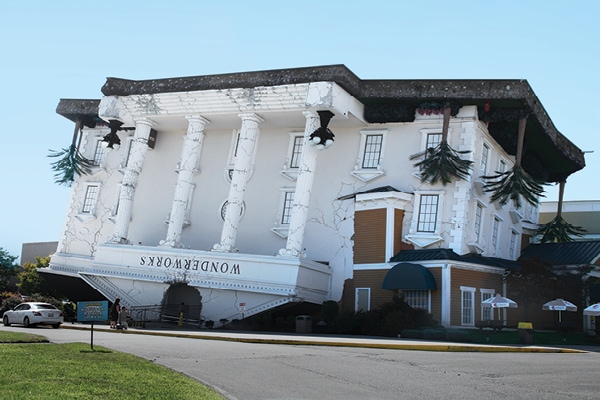 Exterior shop of Wonderworks Musuem themed and cladded to look like an upside-down building.