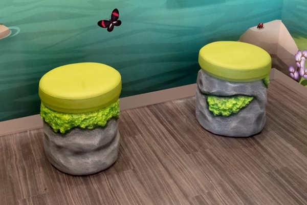 Circular rock cladded stools with vinyl cushions.