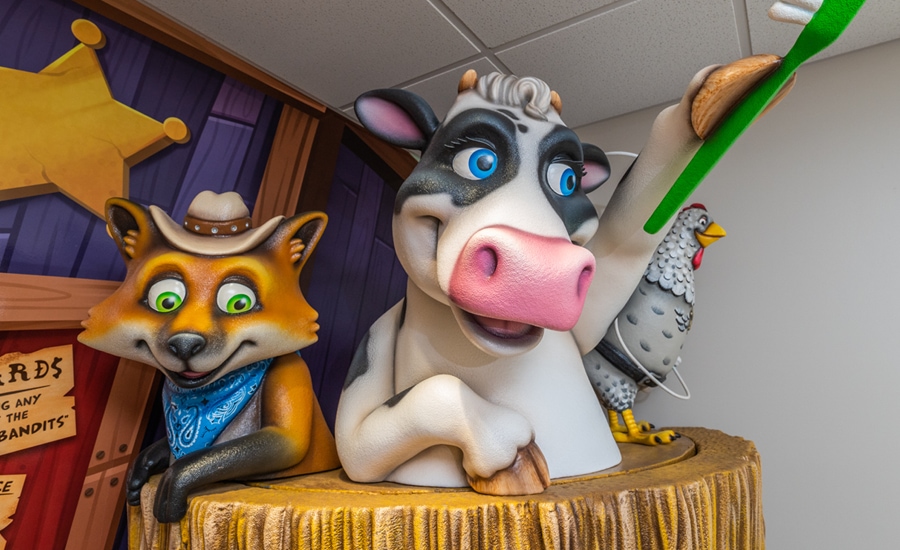 Western themed 3D sculpted characters of a bandana-wearing fox, cow and hen