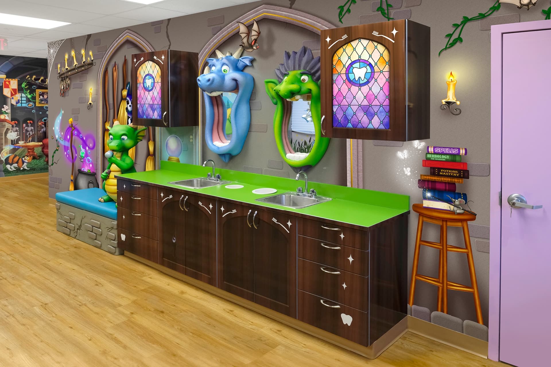 A colorful pediatric dental office showcases a themed environment transformation, featuring cartoon dragon heads on the walls, green countertops with sinks, and whimsical castle-themed decor with books, candles, and stained-glass windows.