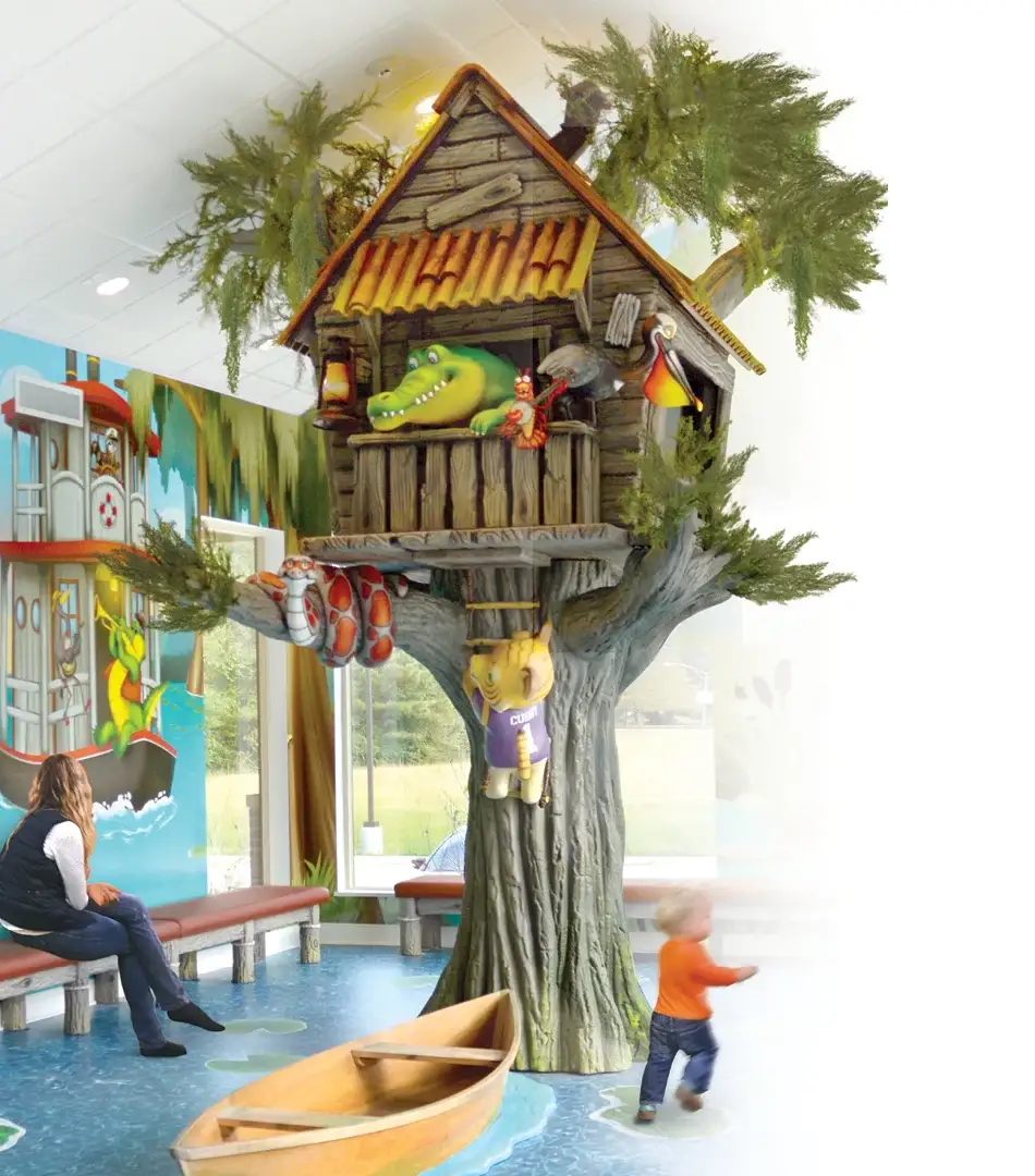Treehouse themed children's play area and waiting room designed for pediatric dental office