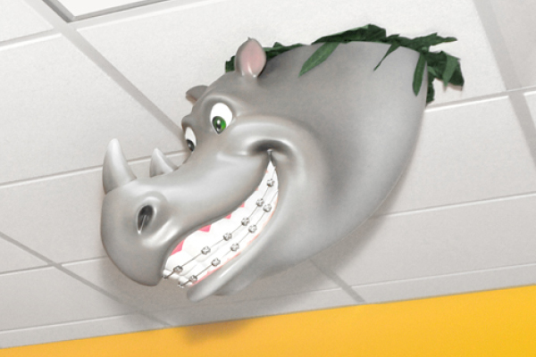 A cartoonish gray hippopotamus head with braces on its teeth appears to be breaking through a ceiling tile, surrounded by green leaves.