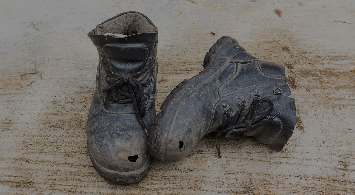 A picture of worn boots with laces