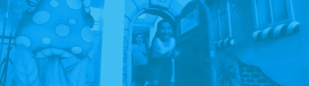 Children running through a colorful themed play environment with immersive wall murals